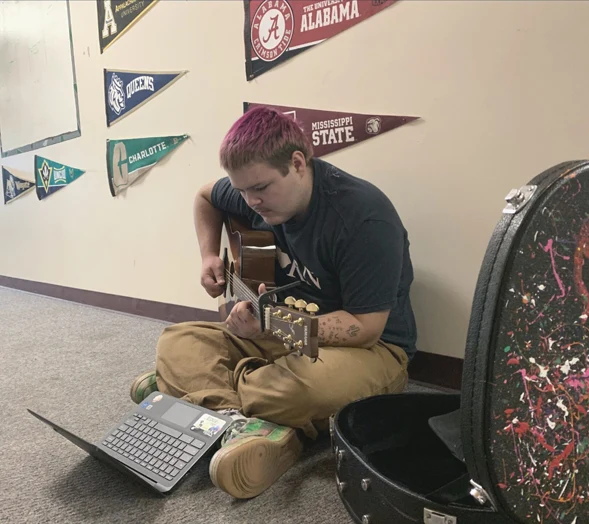 Boy in hallway playing guitar