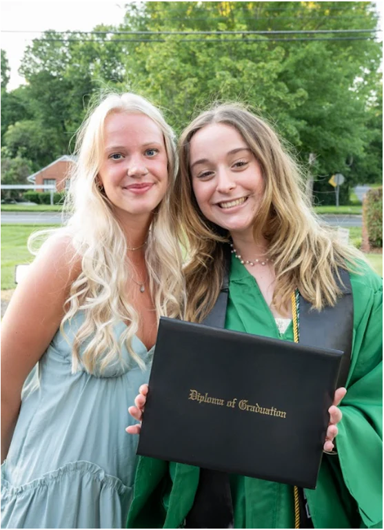 Girls Holding Emerald Diploma of Graduation