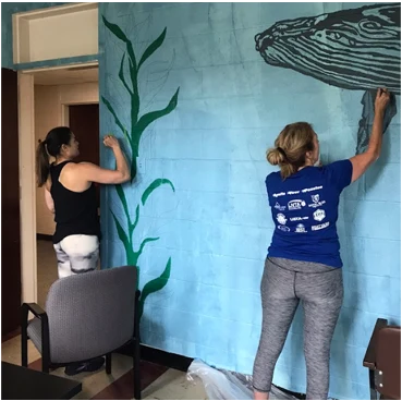 2 women painting at volunteer day