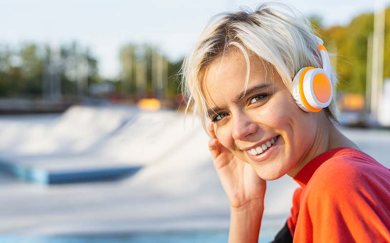 Stylish cool teen female skateboarder at skate park